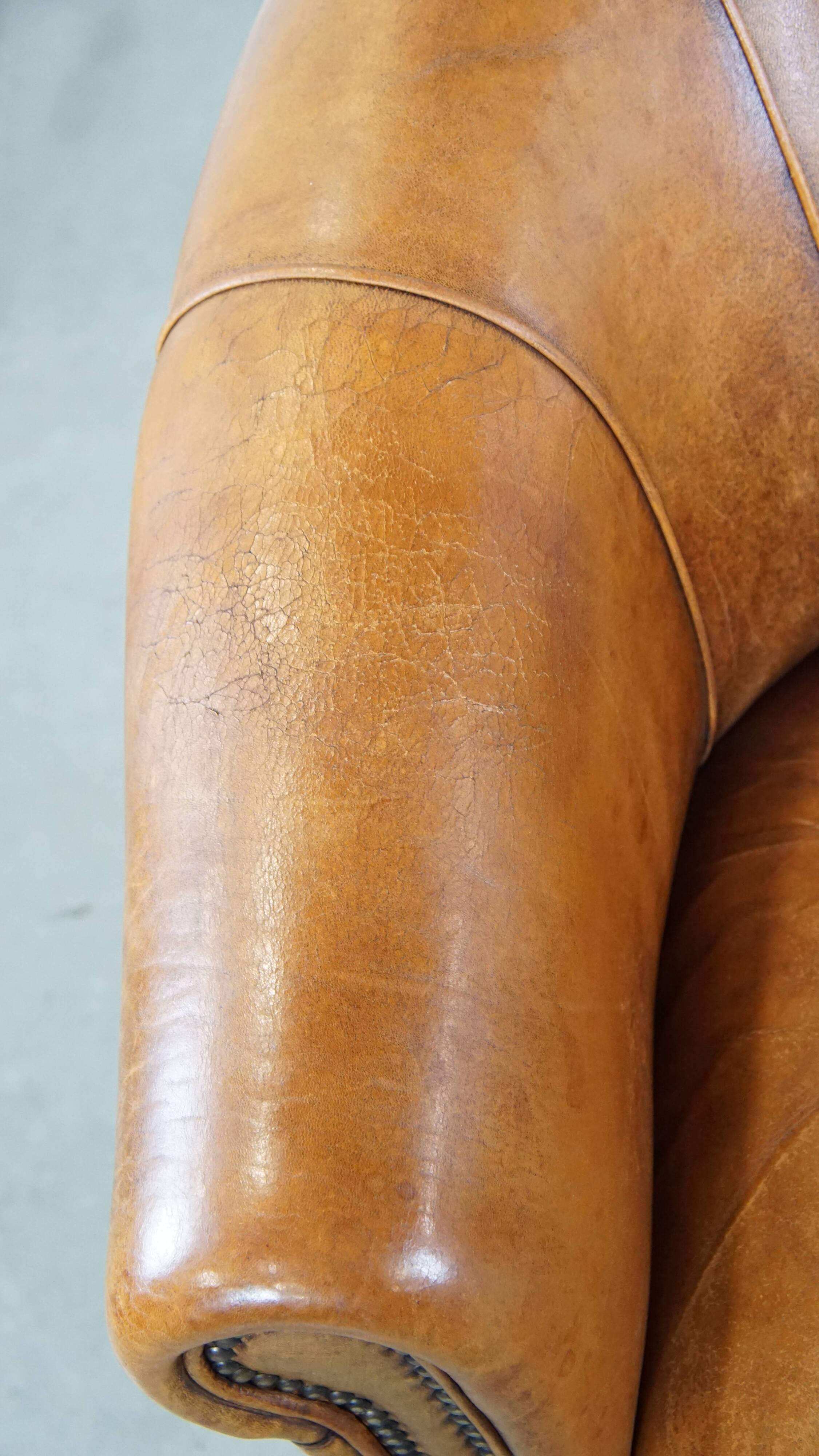 Cognac-colored sheep leather club chair with patina