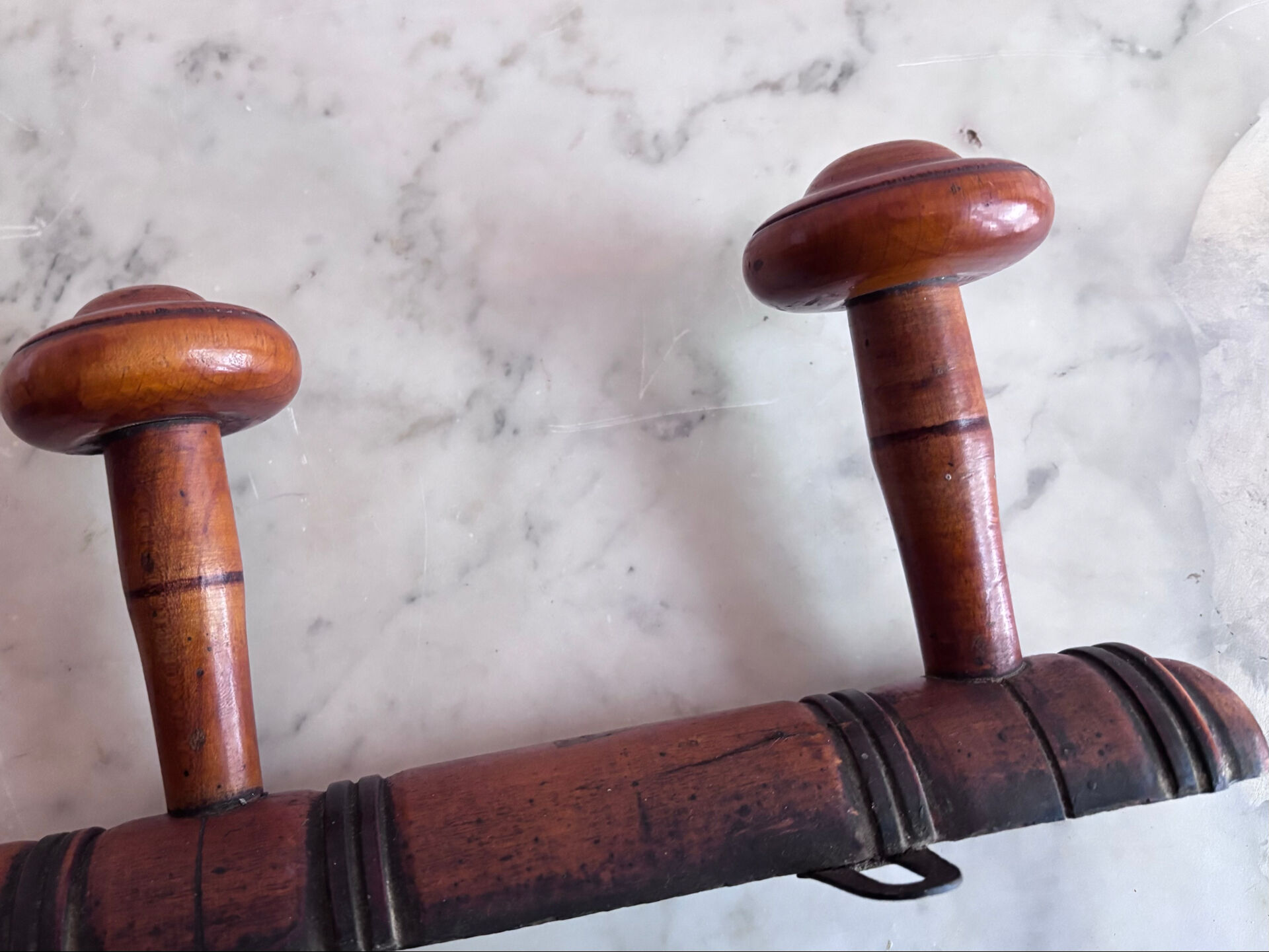 Wall-mounted coat rack with 8 turned wooden hooks in faux bamboo style.