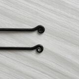 Two small hammered metal teaspoons with a snail pattern.