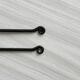 Two small hammered metal teaspoons with a snail pattern.