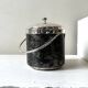 Vintage chrome metal ice bucket with black marbled design, 1970s style.