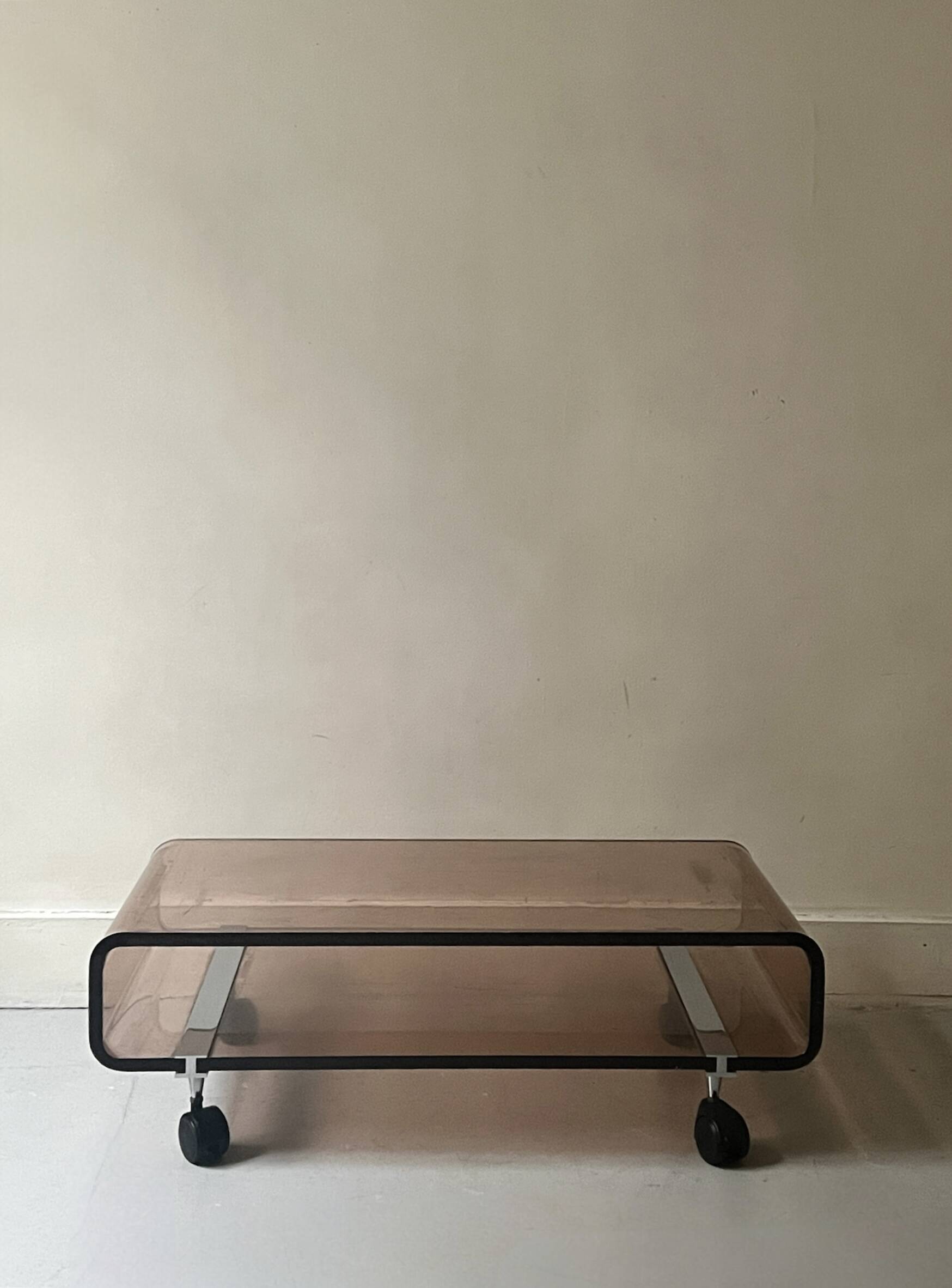 Smoked plexiglass coffee table on wheels, Roche Bobois design 1970.