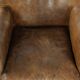 Robust cowhide armchair in a beautifully subtle size with a wonderful patina.