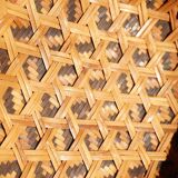 Woven patterned basket, made of straw and bamboo.