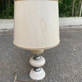 Space age bedside lamp in off-white wood with a metal band.