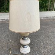 Space age bedside lamp in off-white wood with a metal band.