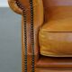 Cow leather wingback chair finished with decorative nails
