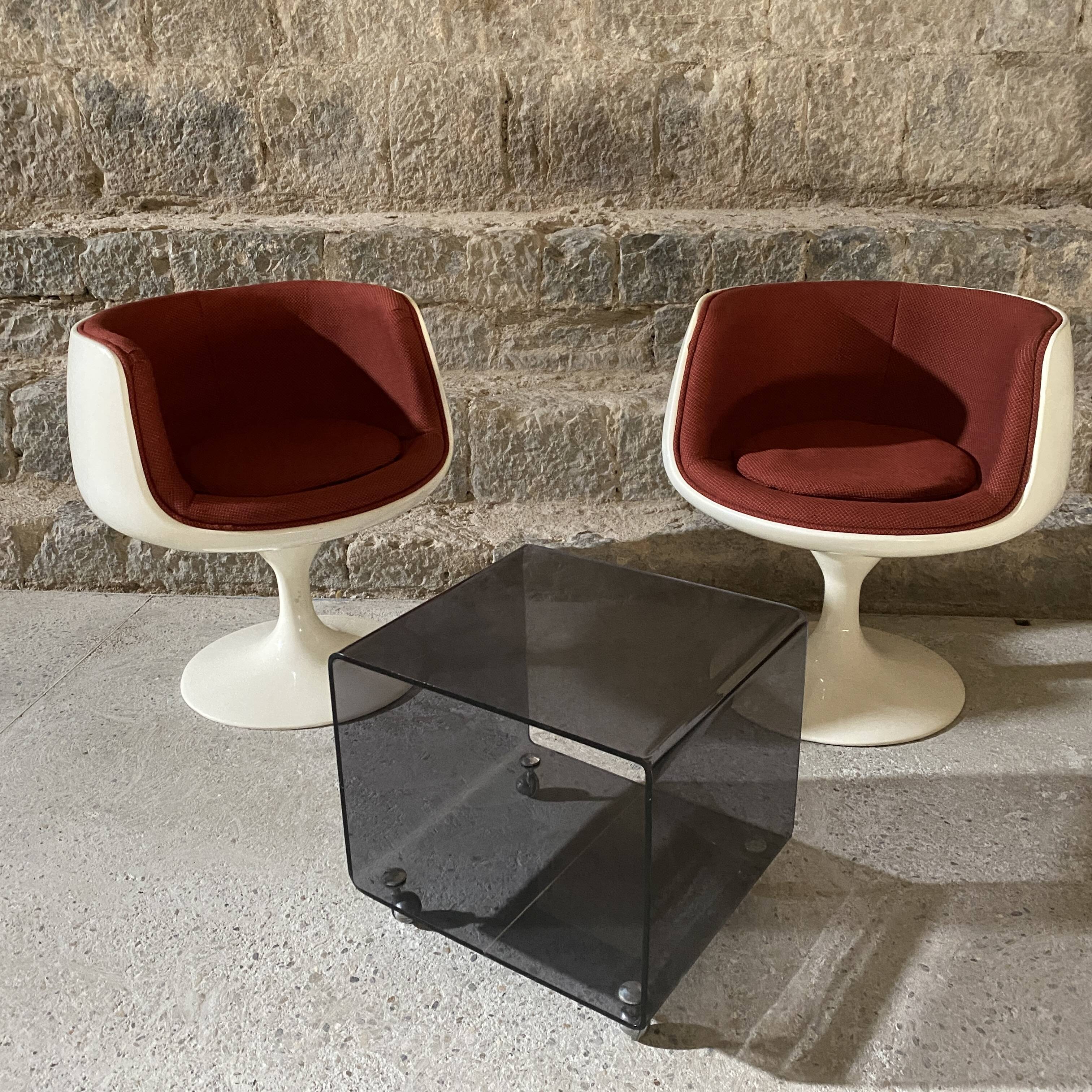 Two cognac-colored swivel chairs made of fiberglass from the 1970s
