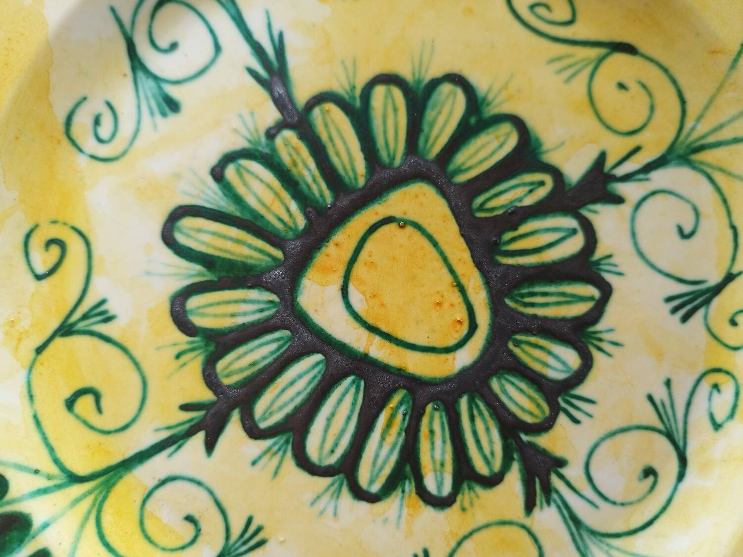Plate decorated with yellow and green flower, signed Kerbigot.