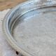 Large round vintage silver-plated metal tray, engraved and pierced.