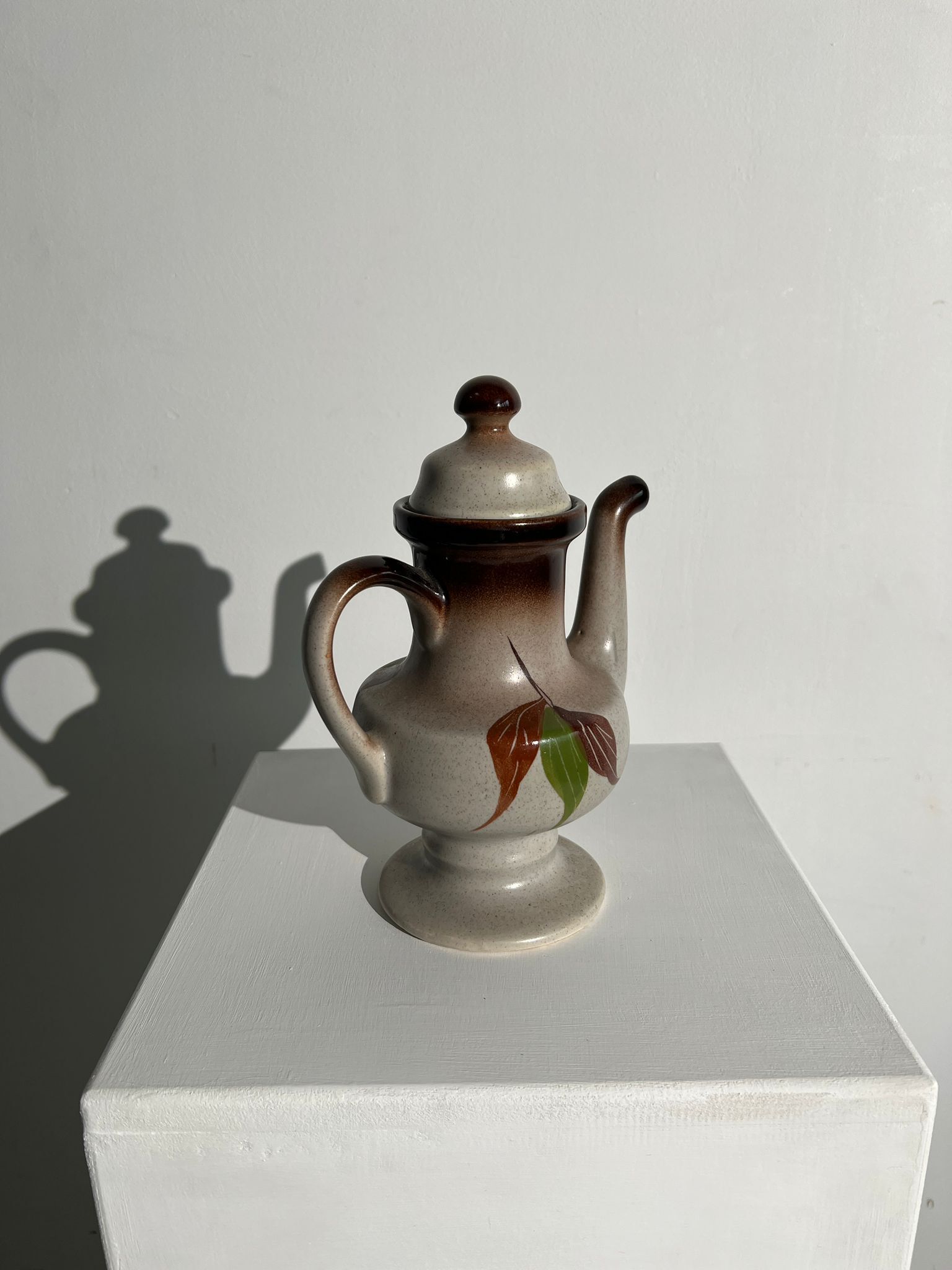 Vintage stoneware teapot with flower and fruit patterns