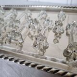 A charming set of 12 molded glass knives rests in the shape of a dog