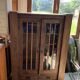 Antique display cabinet in brown oak with glass doors and a drawer, 1890-1919.
