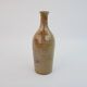 Brown ceramic/stoneware bottle with chiseled floral pattern