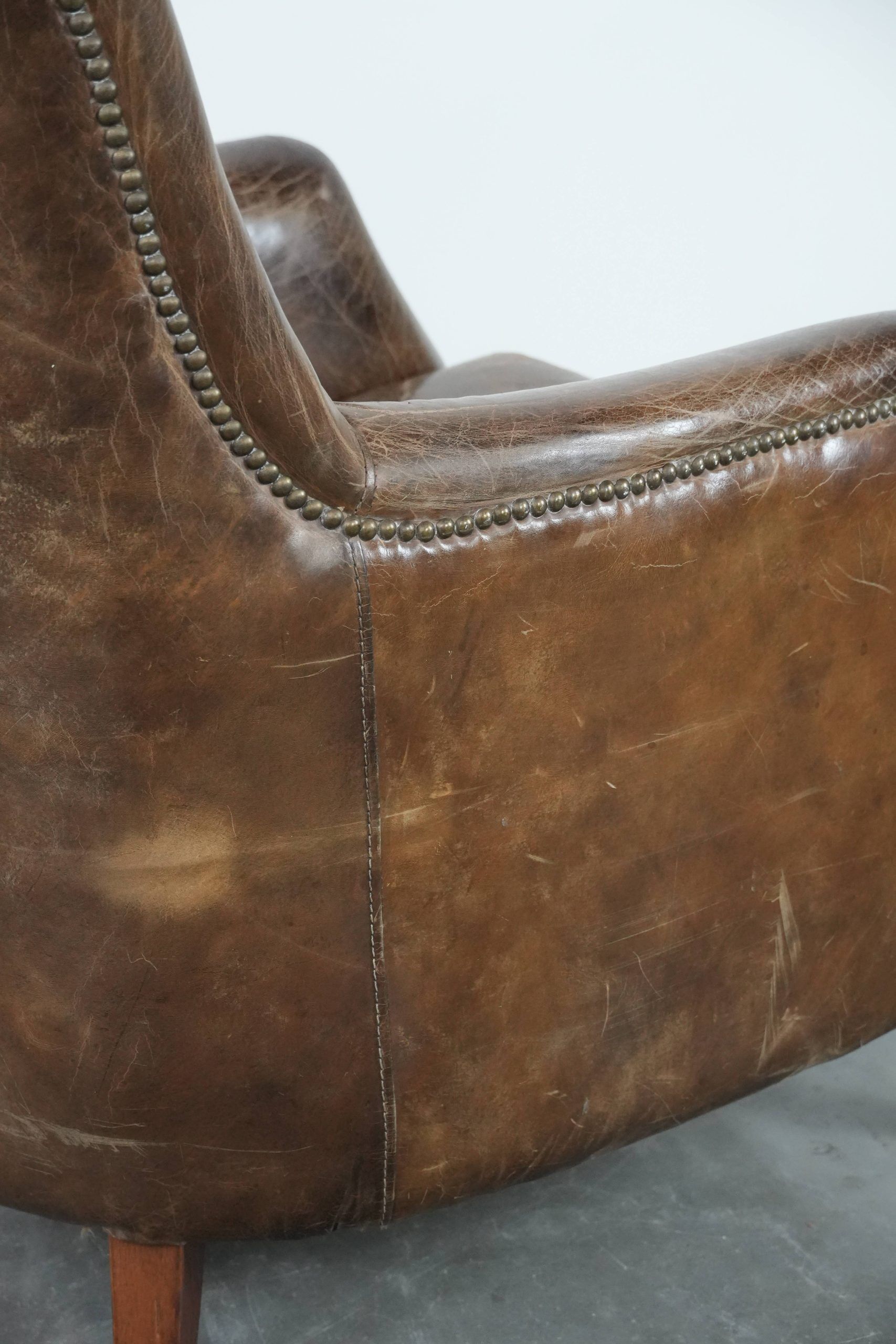 Very comfortable vintage cow leather armchair with beautiful colours