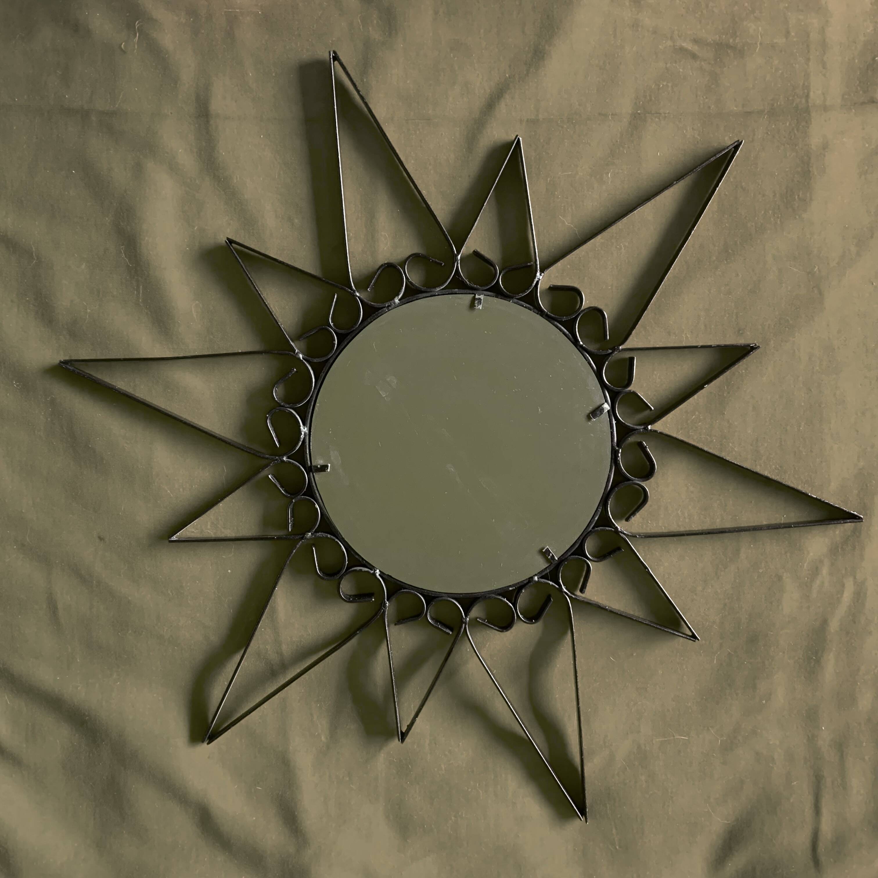 Old wrought metal sun mirror