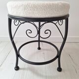 Black iron stool/pouf with its boucle fabric cushion.