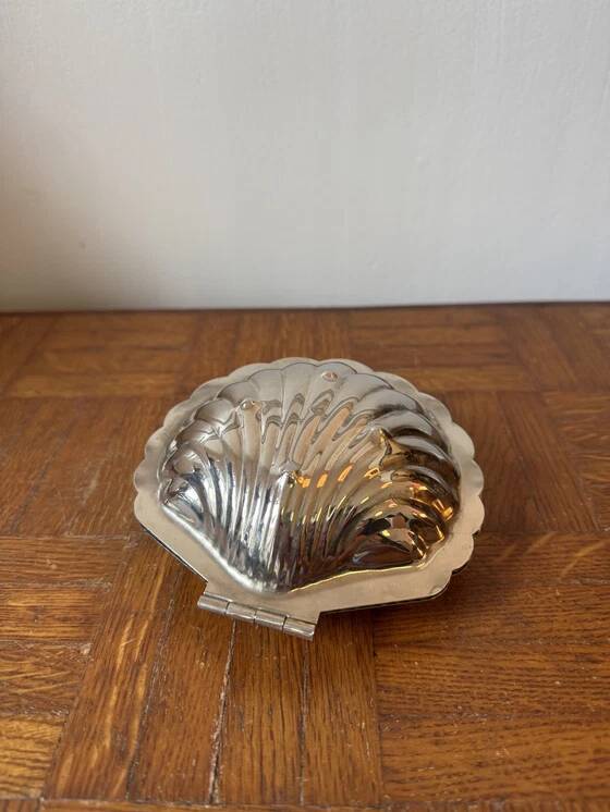 Antique silver-plated metal butter dish in the shape of a seashell
