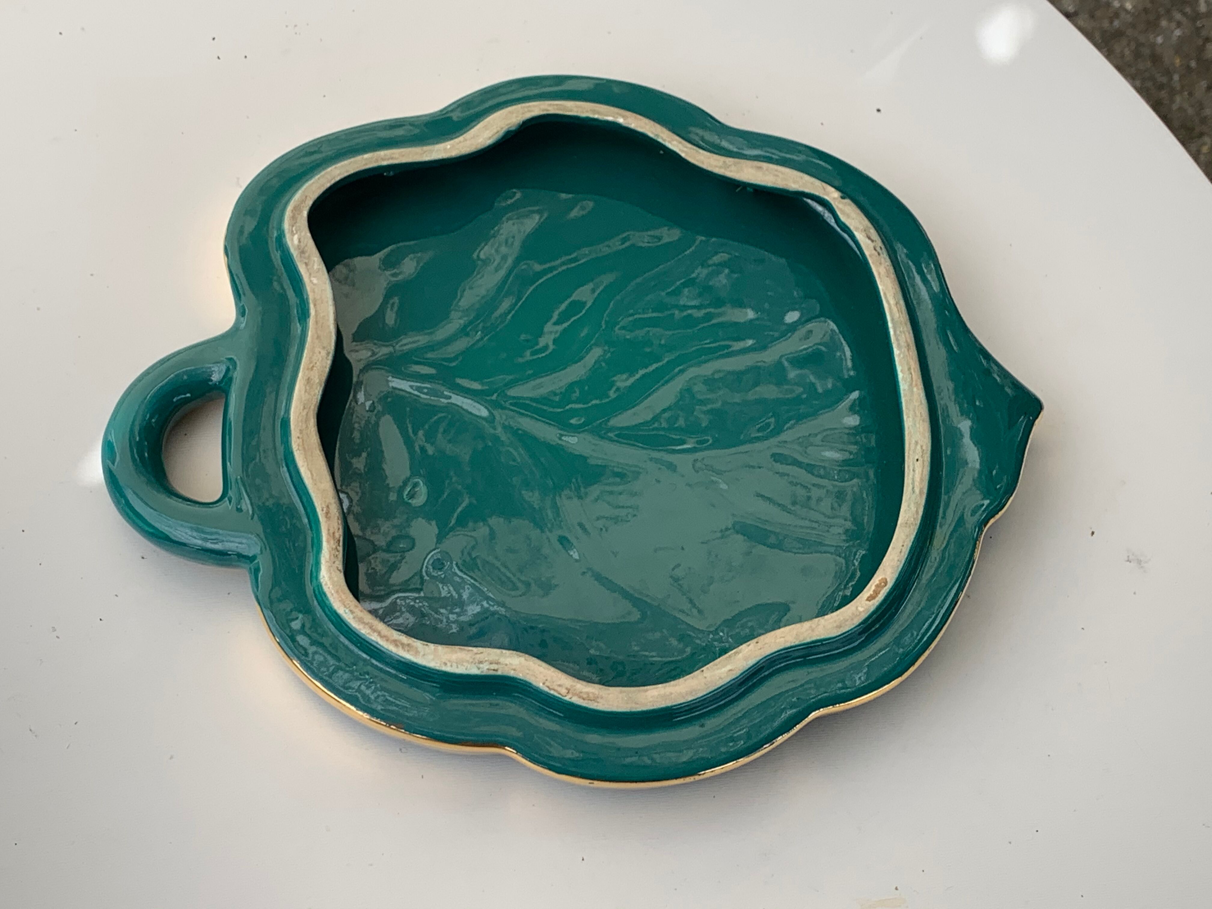 Grained in the shape of vintage dark green enamelled ceramic sheet