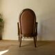 Antique armchair in solid wood and patinated brown leather, early 20th century.