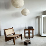 Reclined armchair in canned teak in natural wood