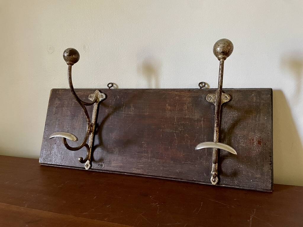 Patinated wood and metal coat rack from the 1950s.