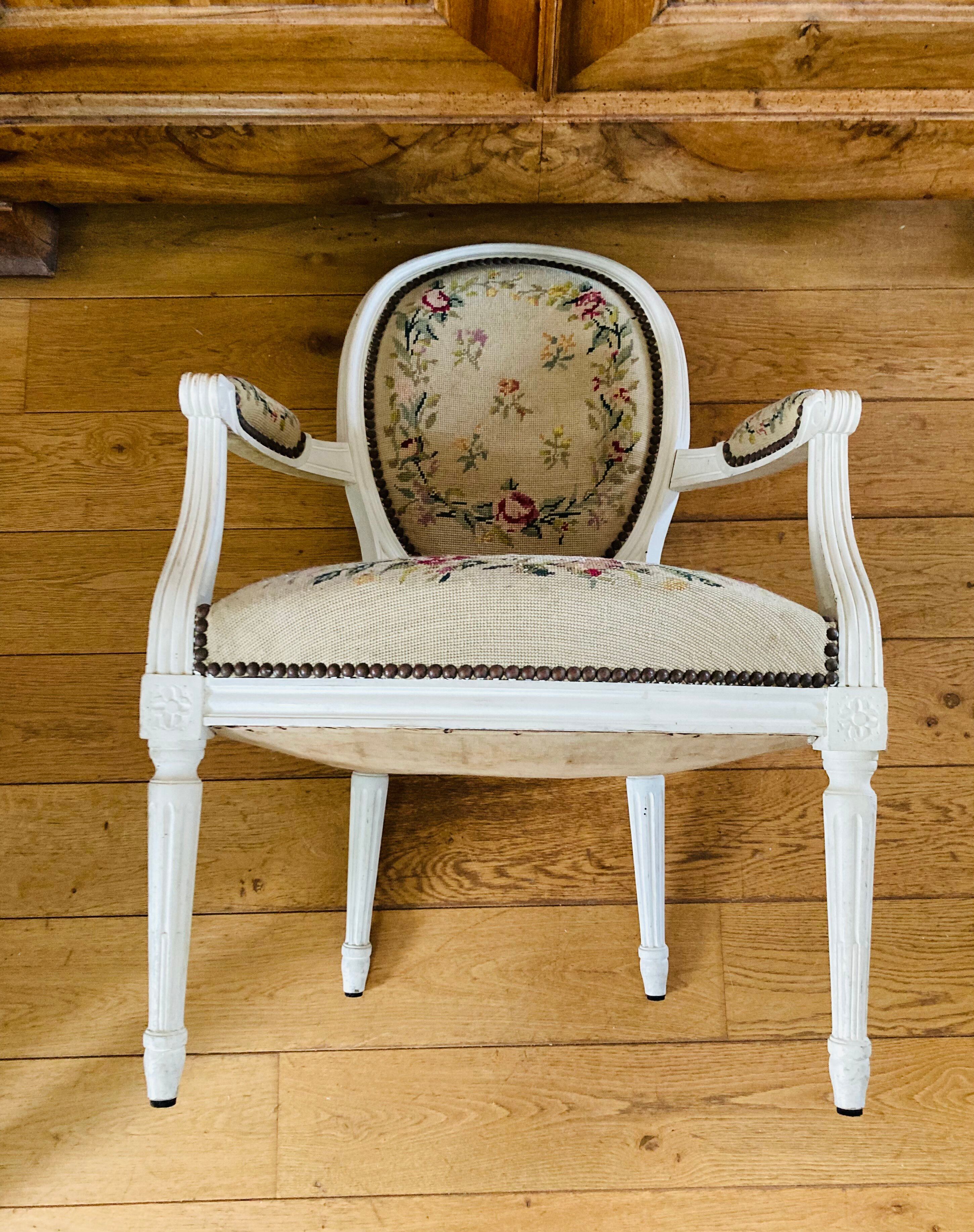 Upholstered armchair with cross-stitch in the Louis XVI style, 19th century.