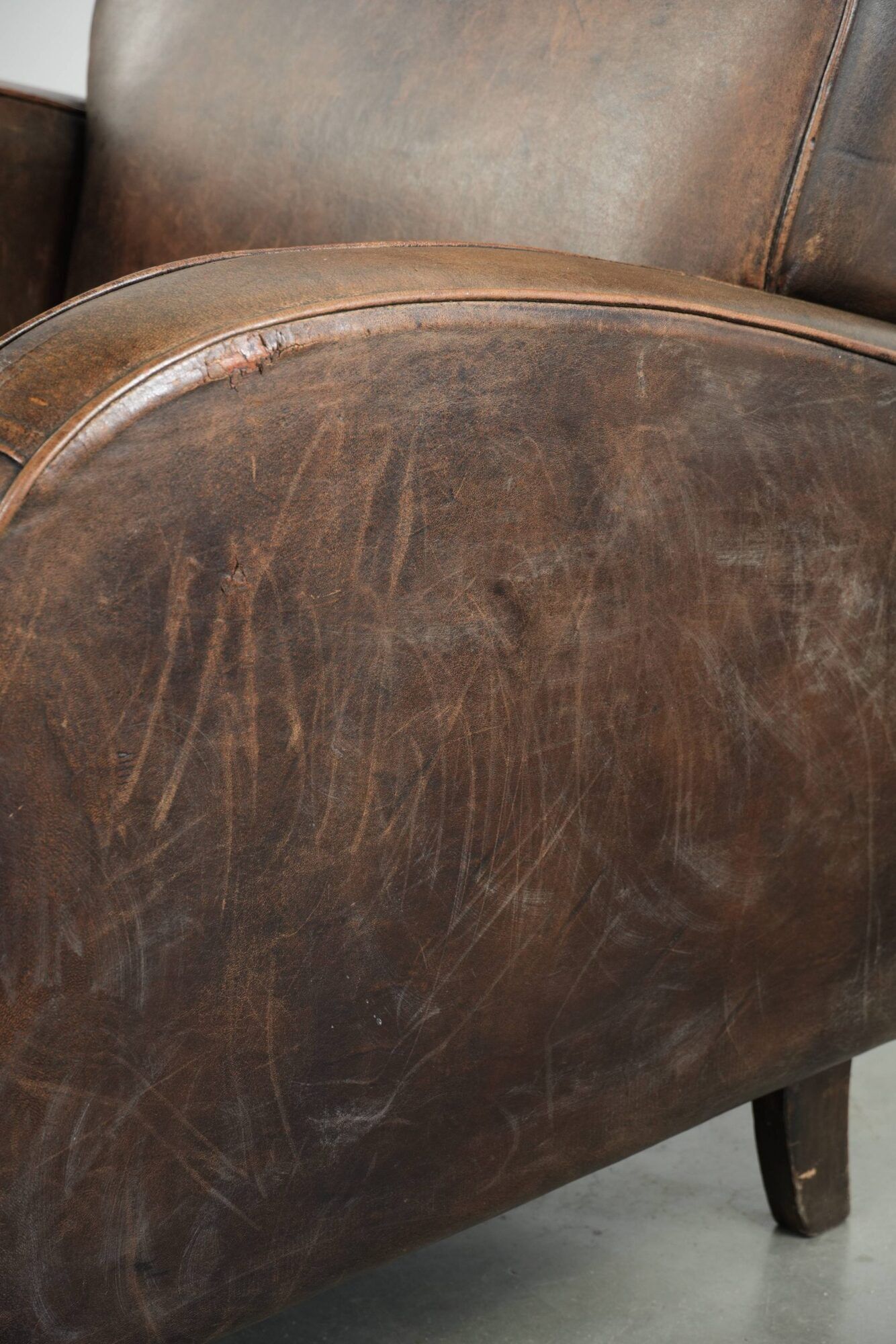 Comfortable sheepskin armchair with matching piping and a timeless look