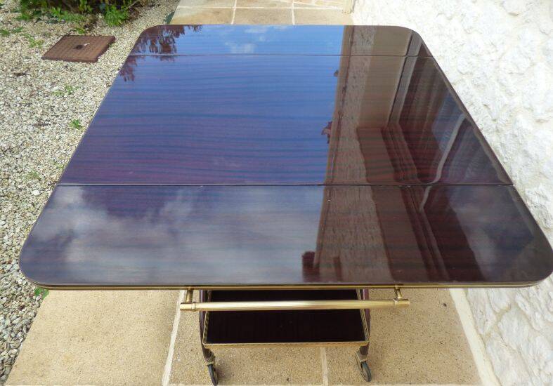 Chic serving table on wheels from the 60s with brass decorations and two shelves.