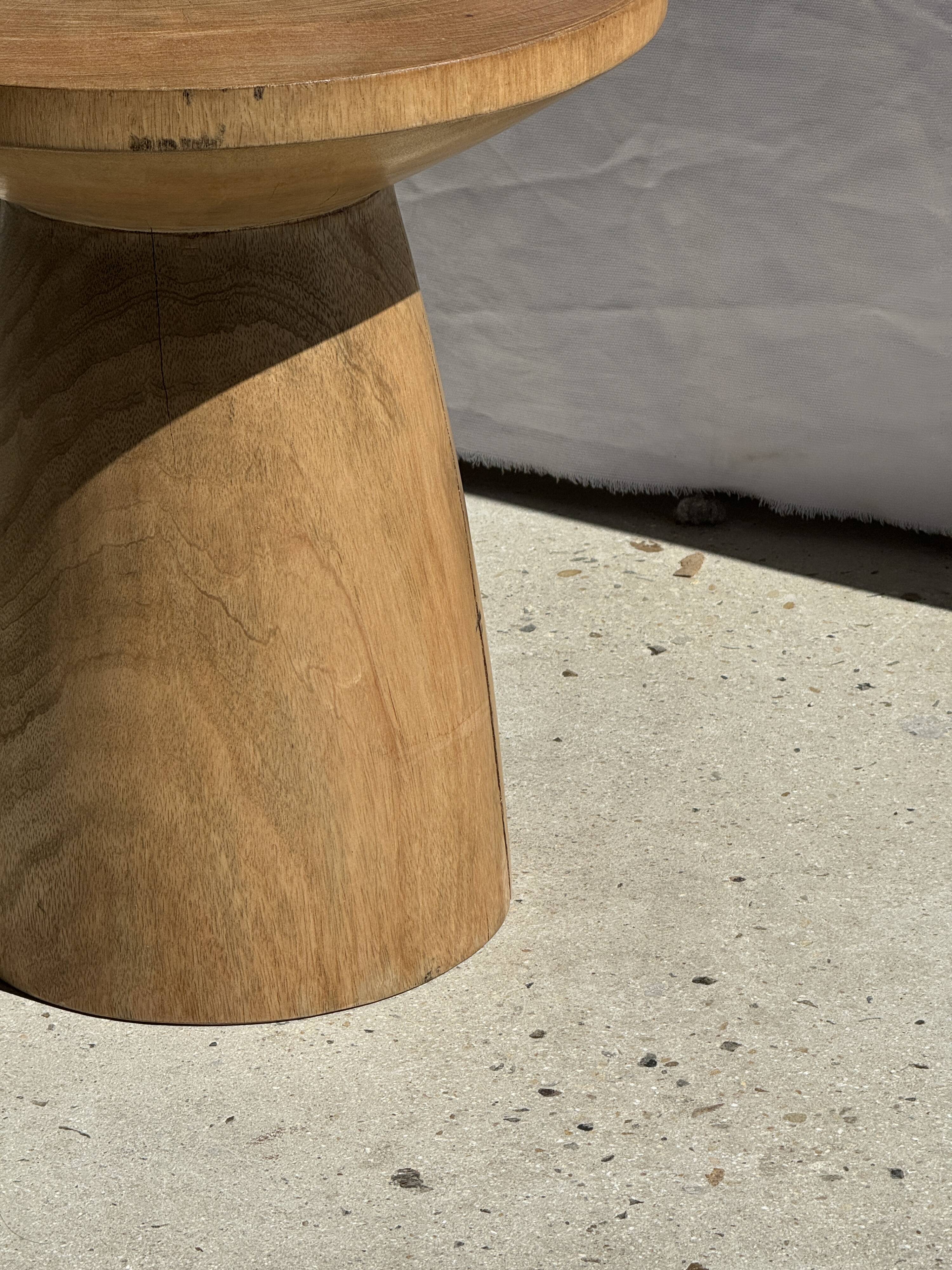 Natural solid mango side table (monoxyle) with conical legs.