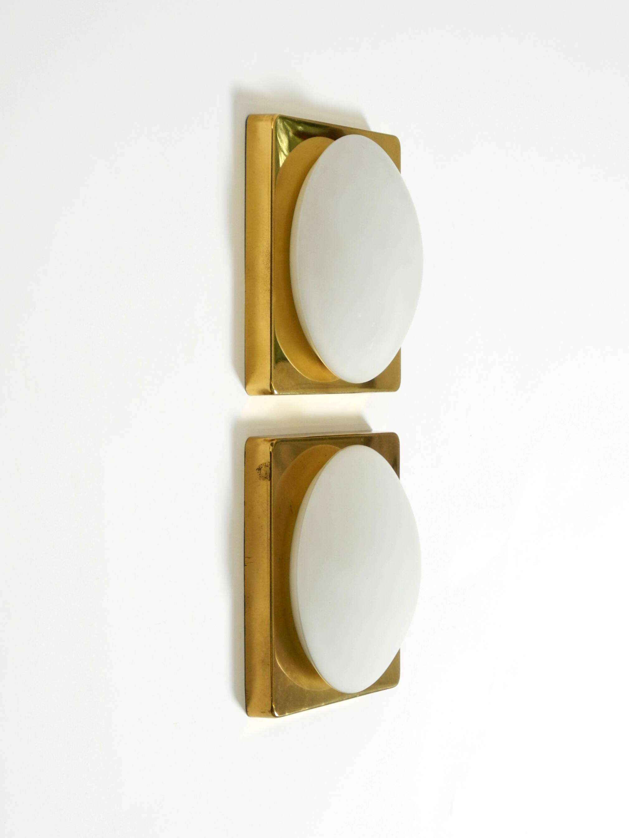 Two 1970s brass wall lamps by Rolf Krüger for Heinz Neuhaus Leuchten