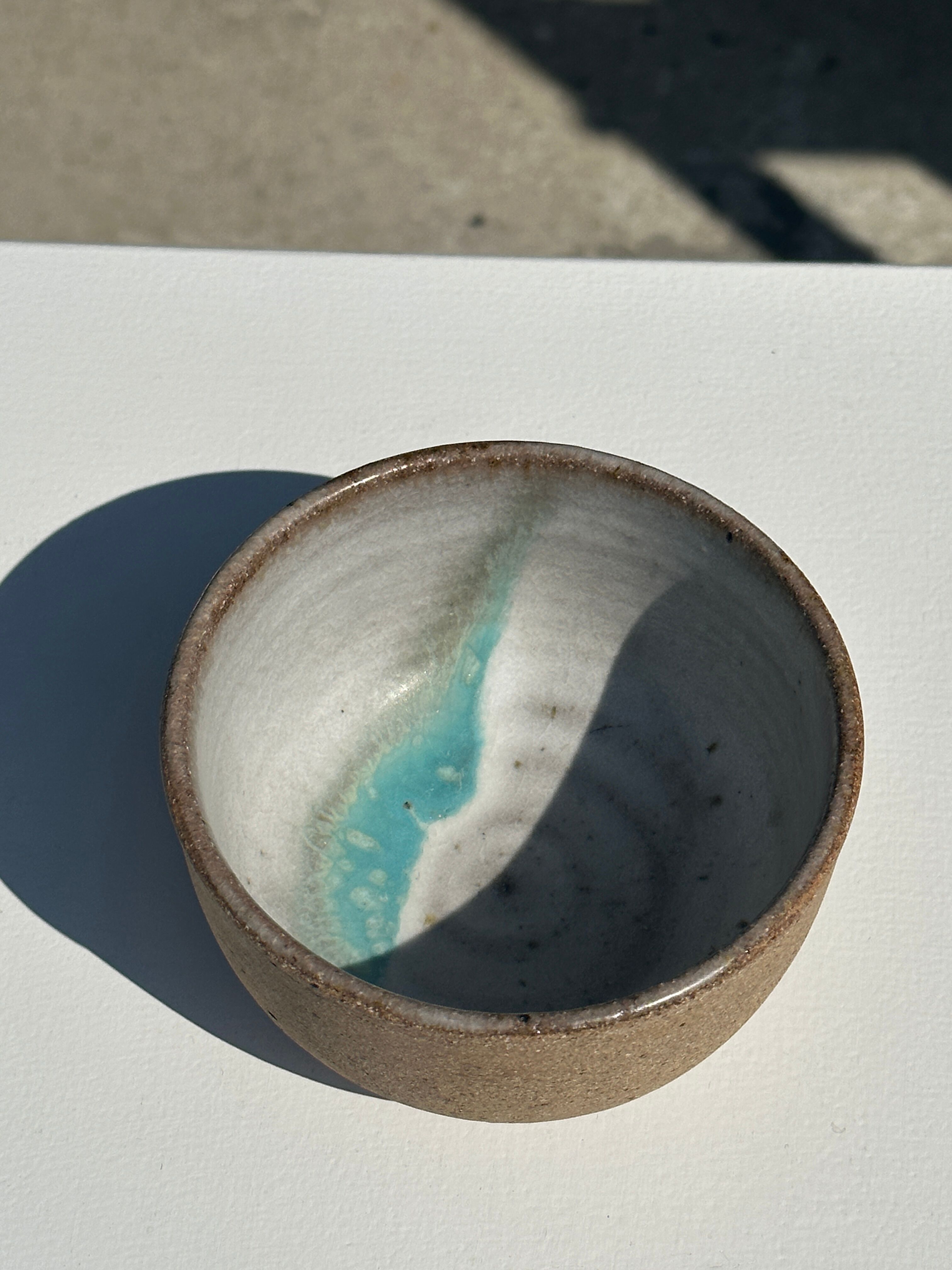 Small brown bowl inside blue and white