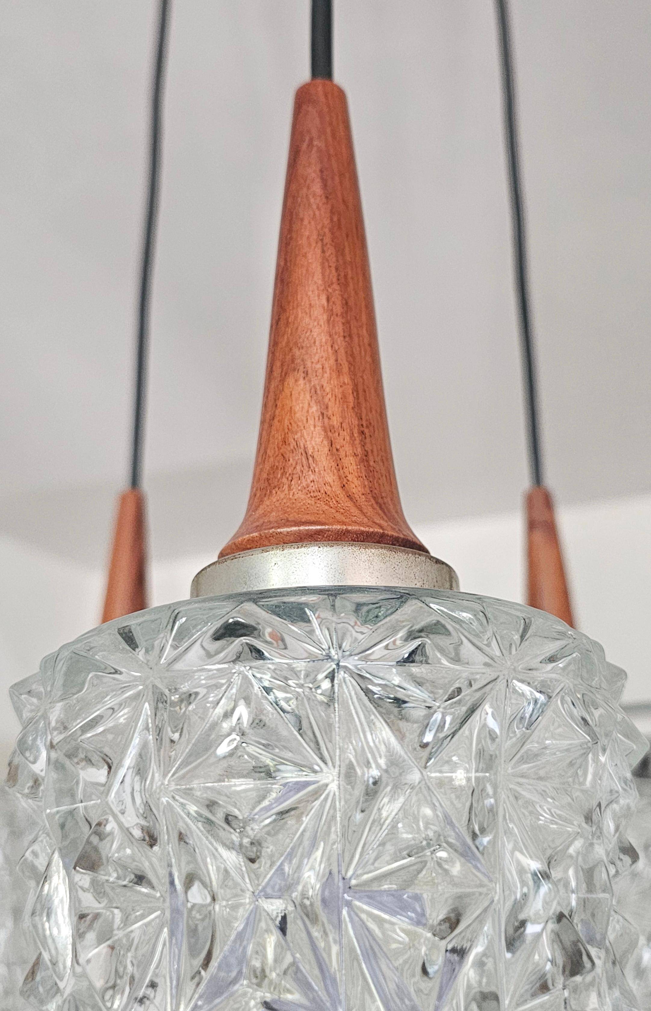 Mid Century Modern spider chandelier in teak, rosewood, and crystal.