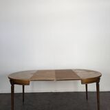 Louis XVI style dining table with a leather top.