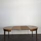 Louis XVI style dining table with a leather top.
