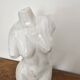 Sculpture of a female torso in white marble.