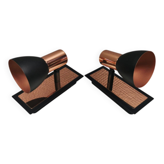 A pair of wall lamps from Eglo, in copper color and black.