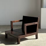 Small low armchair in varnished brown wood