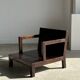 Small low armchair in varnished brown wood