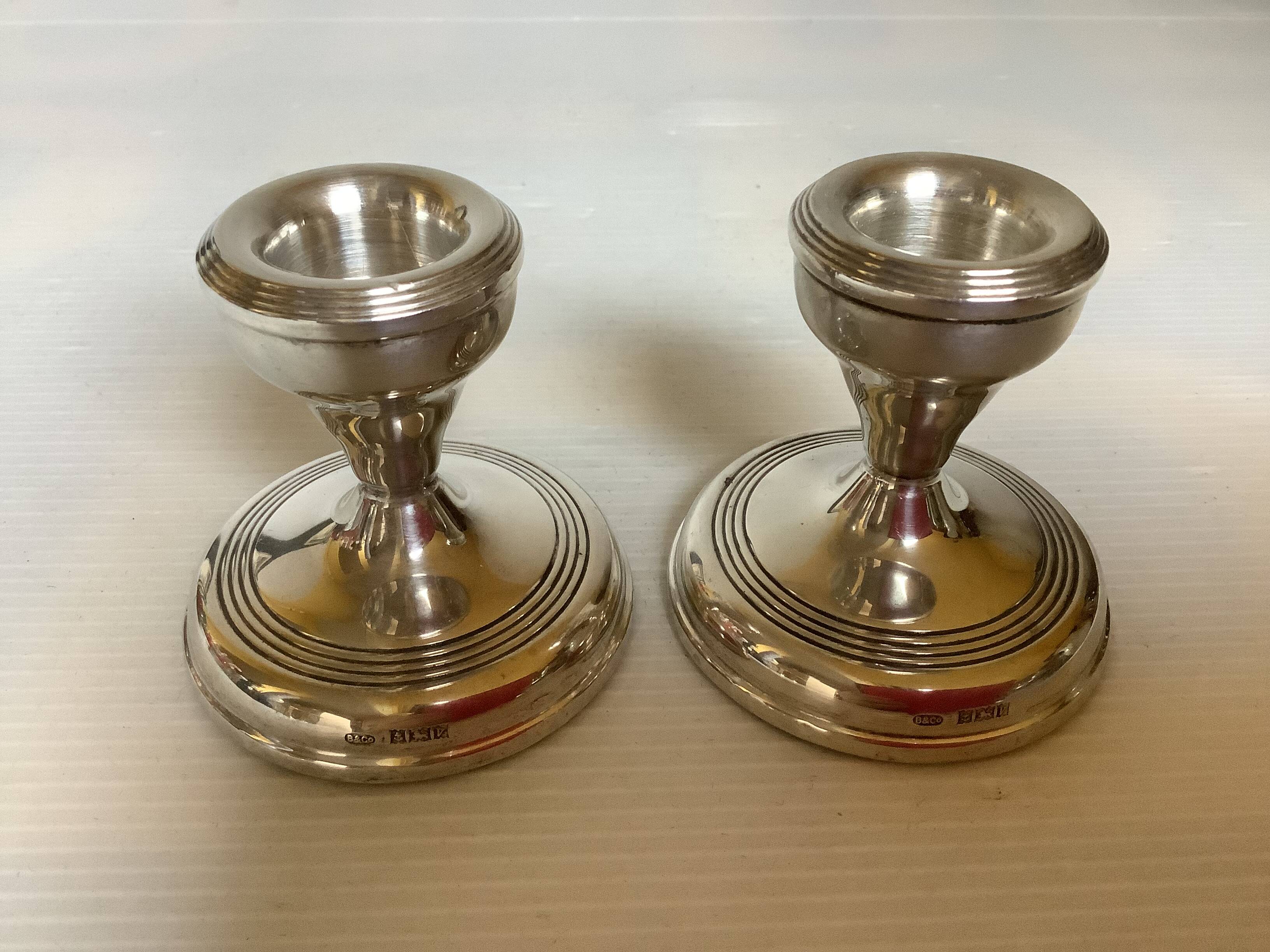 Pair of small silver candlesticks with hallmarks