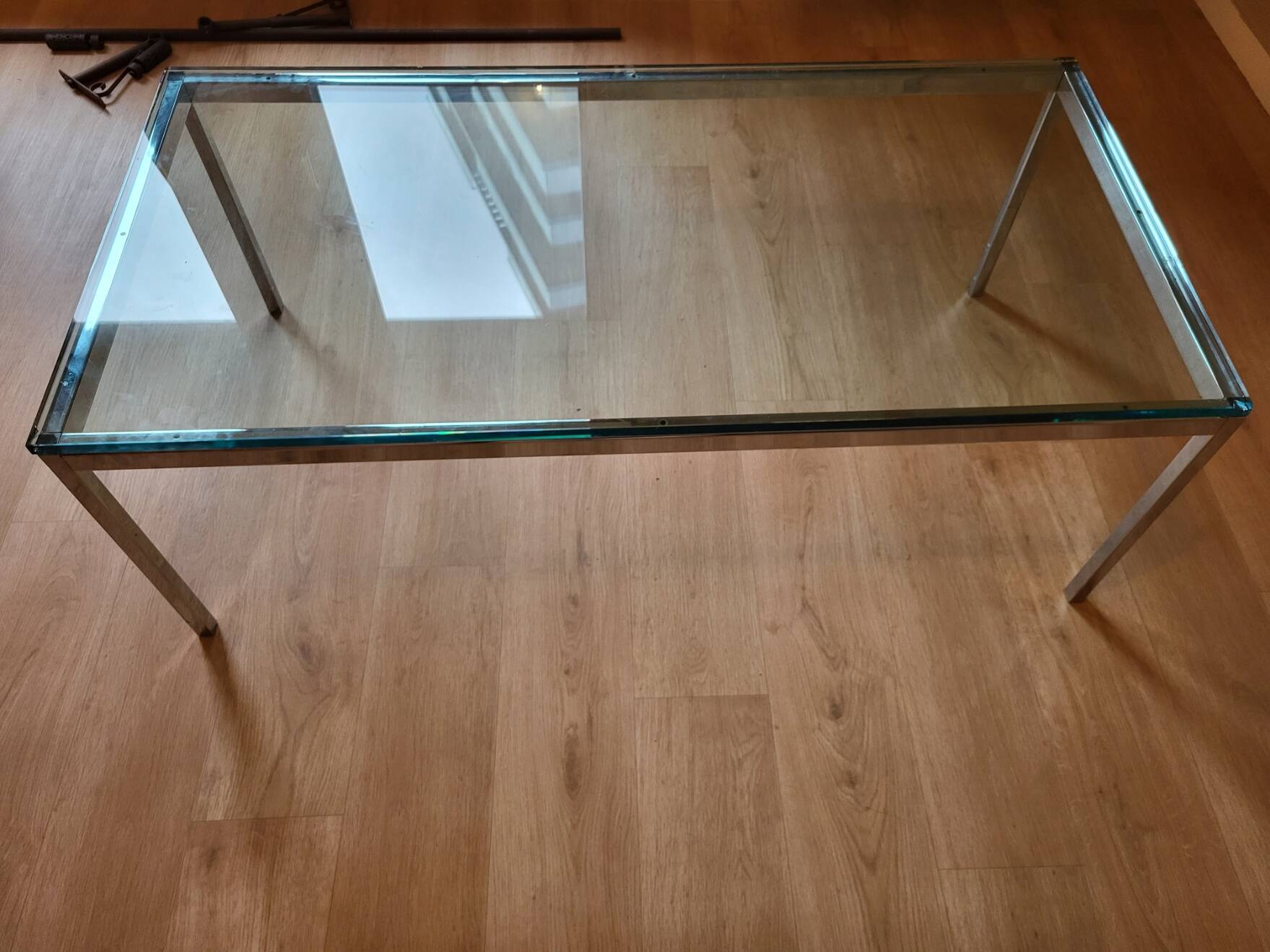 Knoll coffee table with smoked glass top and chrome metal.