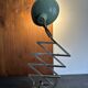 Old extendable accordion lamp in celadon green, workshop spirit.