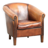 Vintage sheepskin club armchair finished with black piping