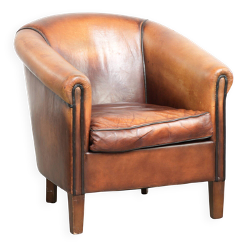 Vintage sheepskin club armchair finished with black piping