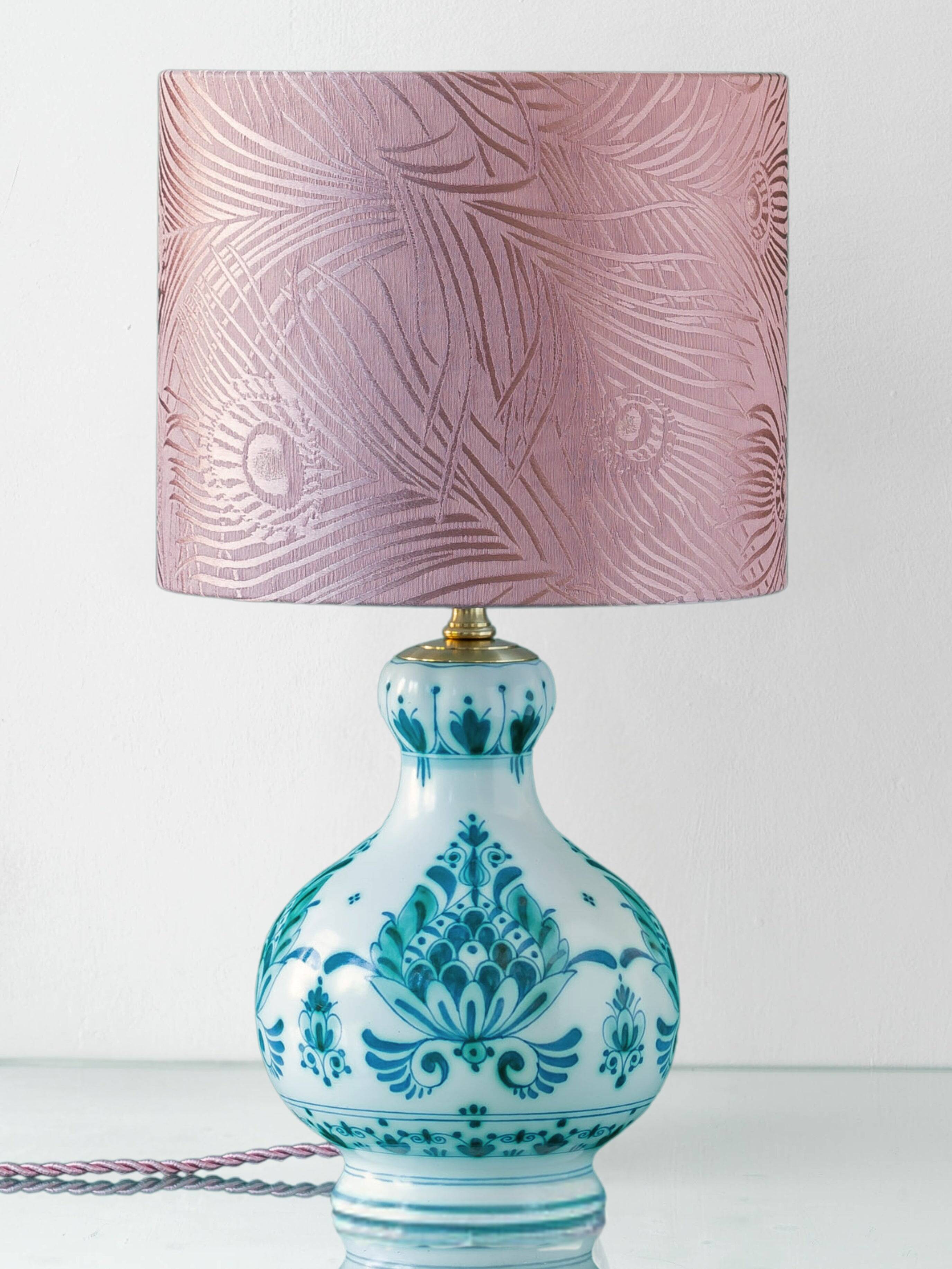 Royal Delft blue-green ceramic table lamp with pink jacquard peacock shade.