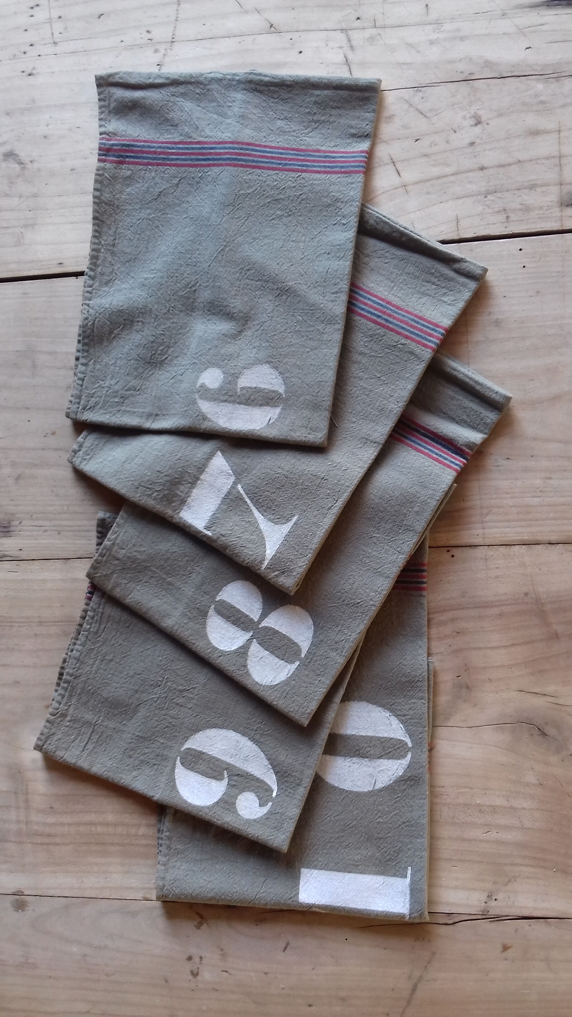 10 numbered khaki tea towels
