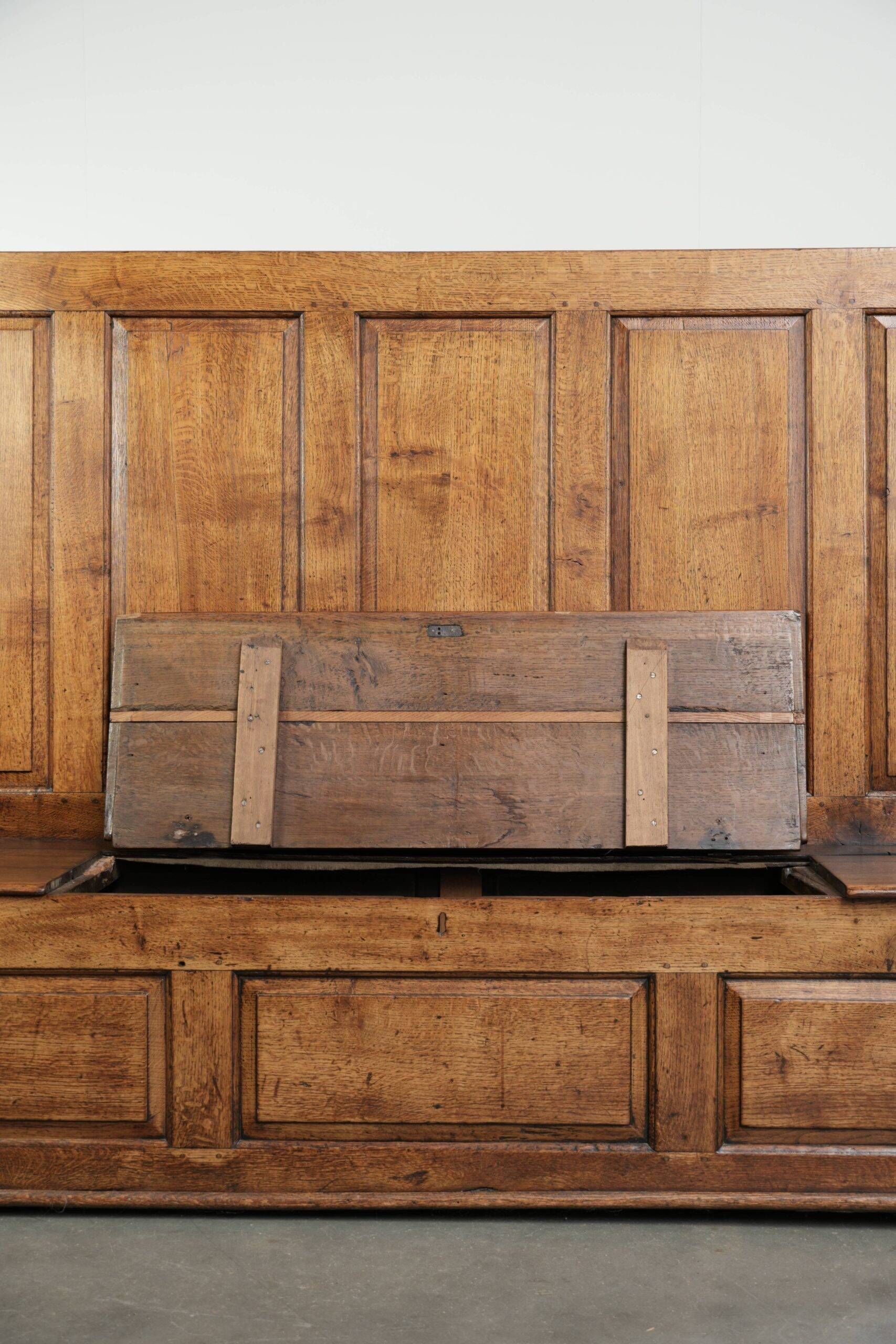 Antique English oak hall bench from the early 19th century with storage space