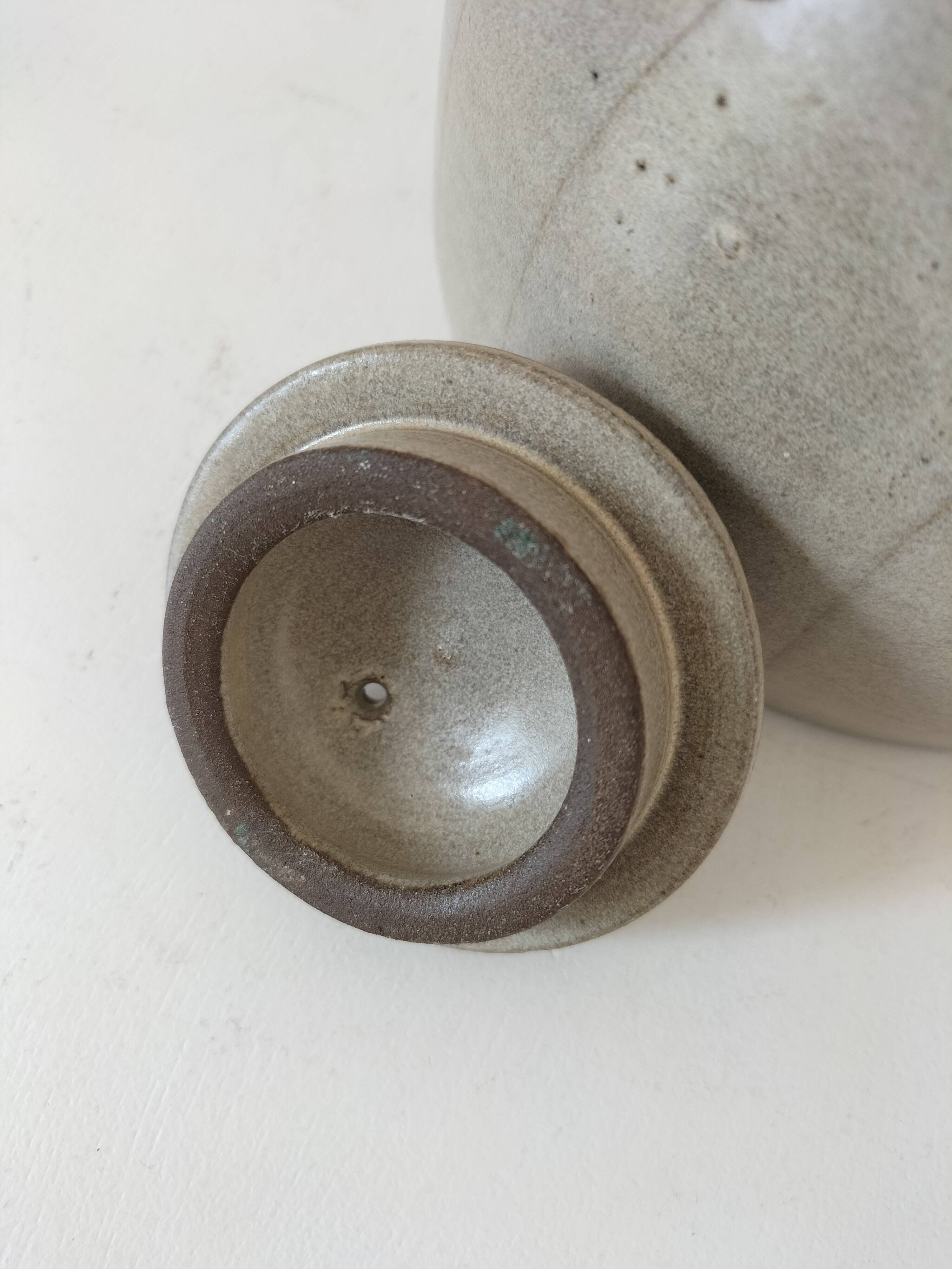 Beige stoneware teapot with stylized flowers and rattan handle