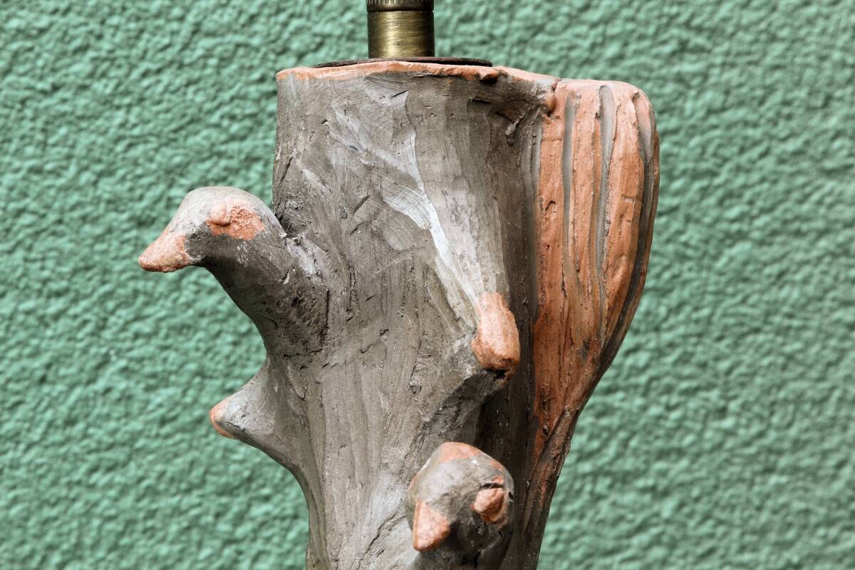 Lamp base in sculpted terracotta featuring birds, signed.