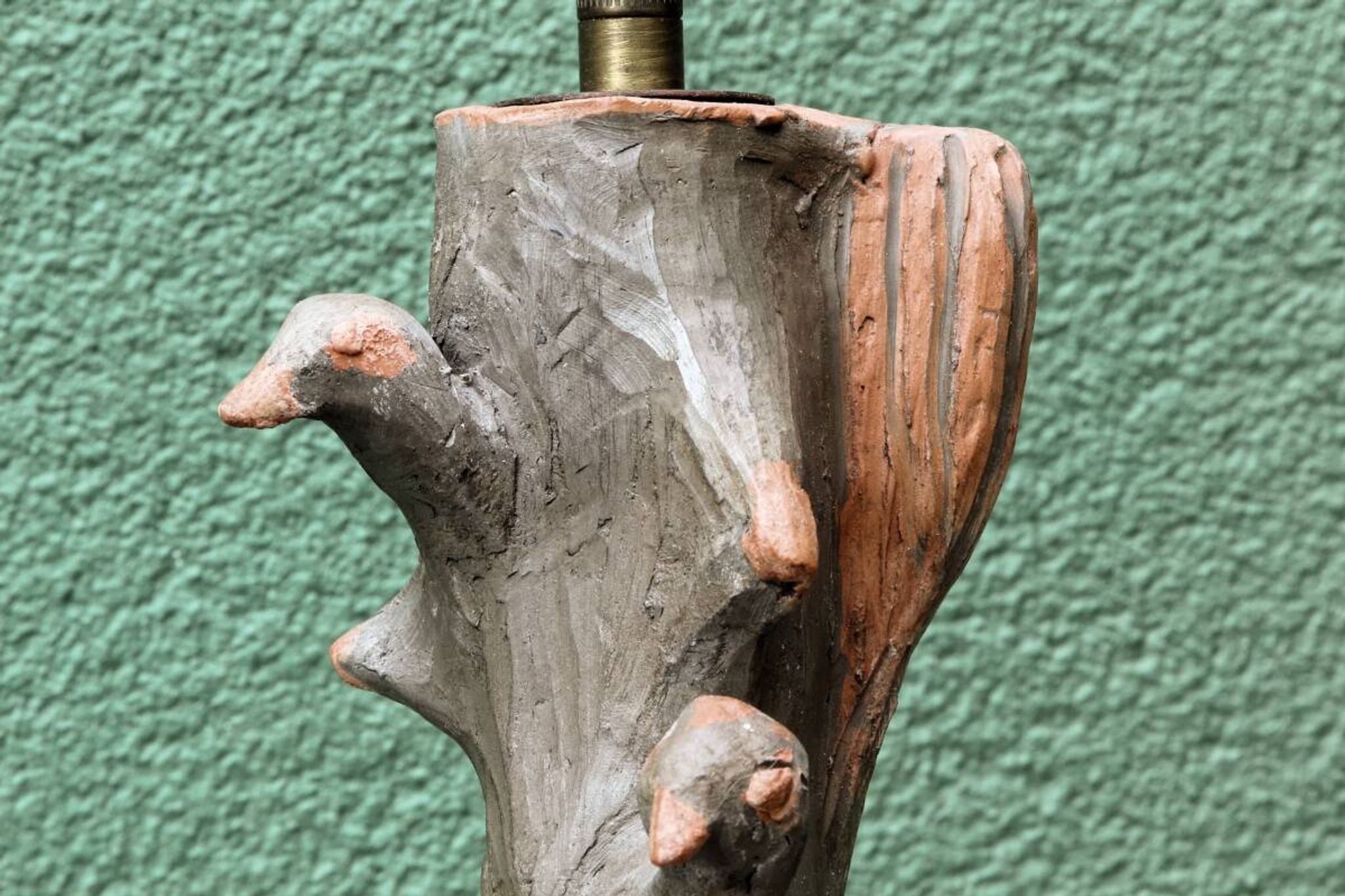 Lamp base in sculpted terracotta featuring birds, signed.